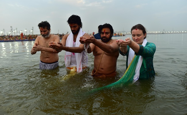 Pawan with his wife takes a holy dip in Maha Kumbh